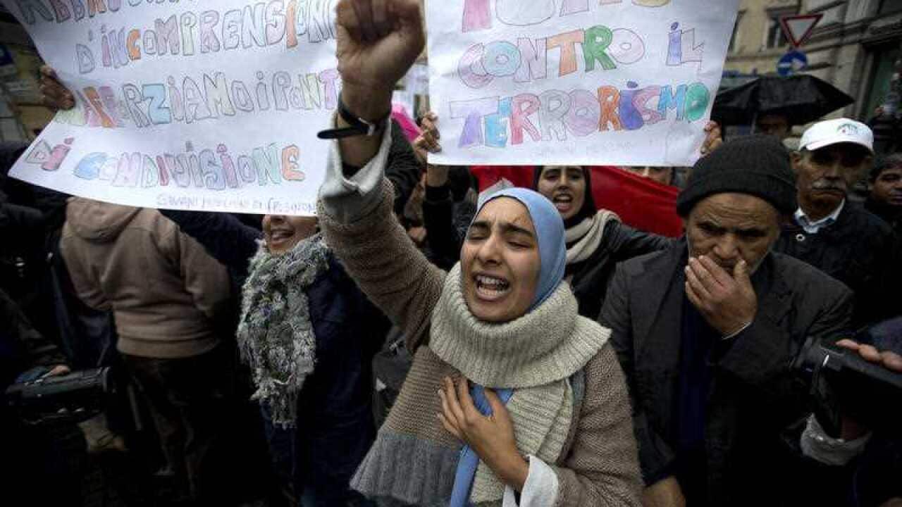 A woman shouts slogans during a demonstration organized by the UCOII (Italian Union of the Islamic Communities) against violence, in downtown Rome.