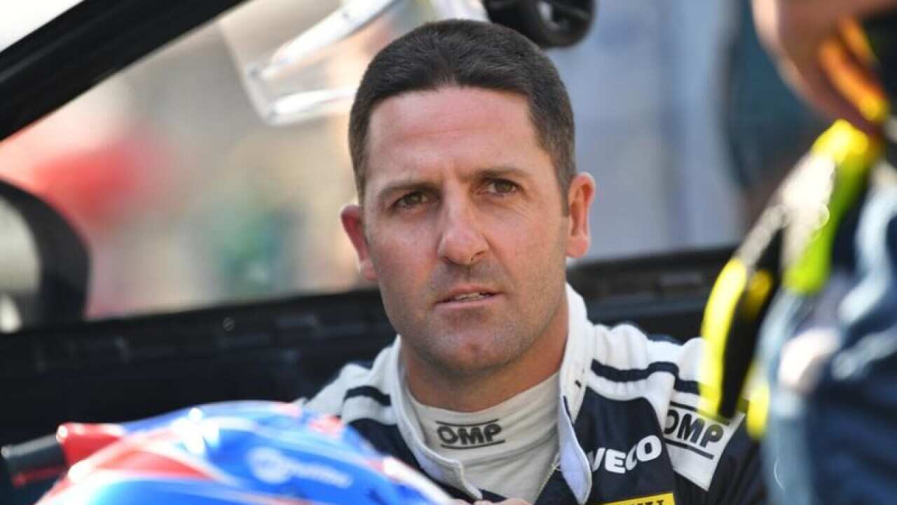 Jamie Whincup waits on the grid before the race