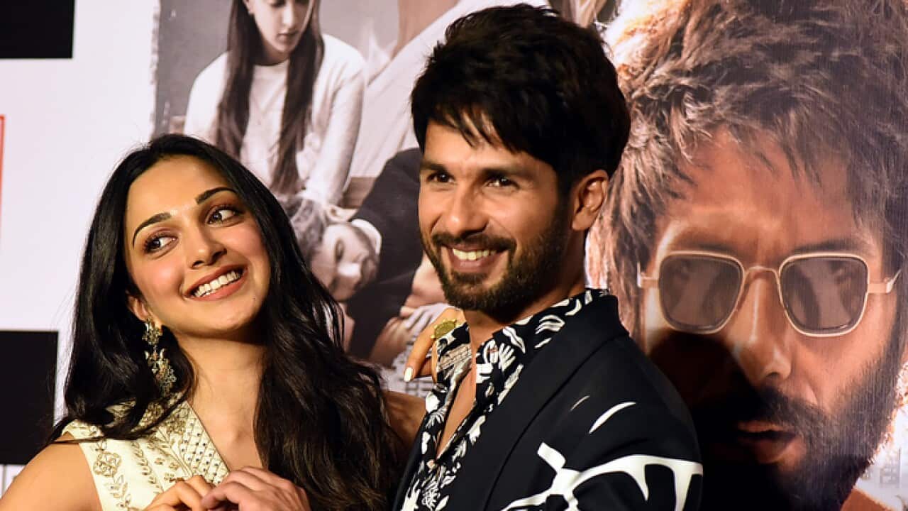 Indian Bollywood actress Kiara Advani (L) and actor Shahid Kapoor (R) pose for photographs during the trailer launch of the upcoming Hindi film 'Kabir Singh'.