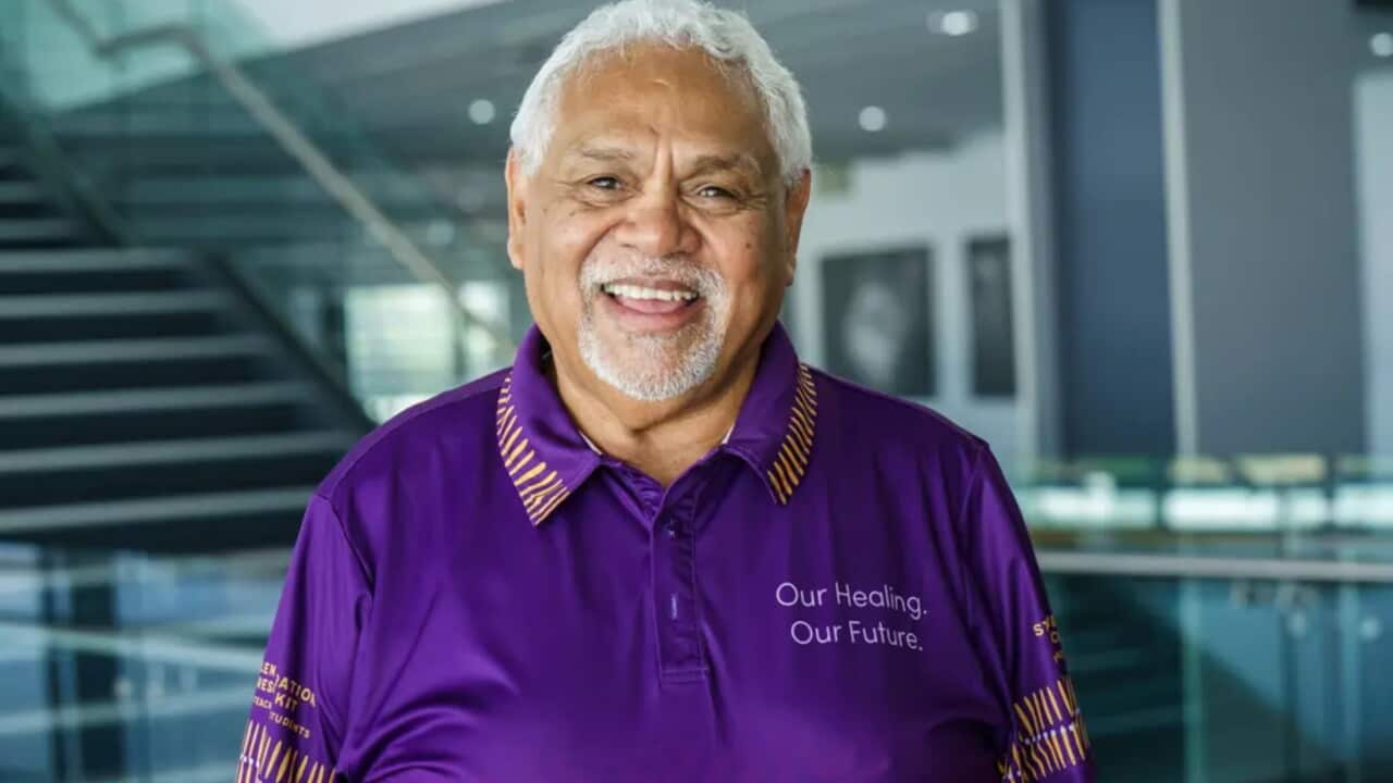 A smiling David Wragge in a purple shirt.