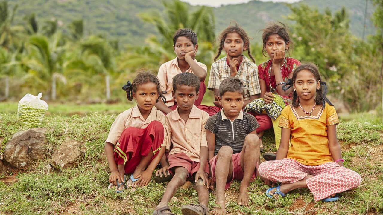Group of cheerful teen village friends sitting on farm land - Model, not related to the story
