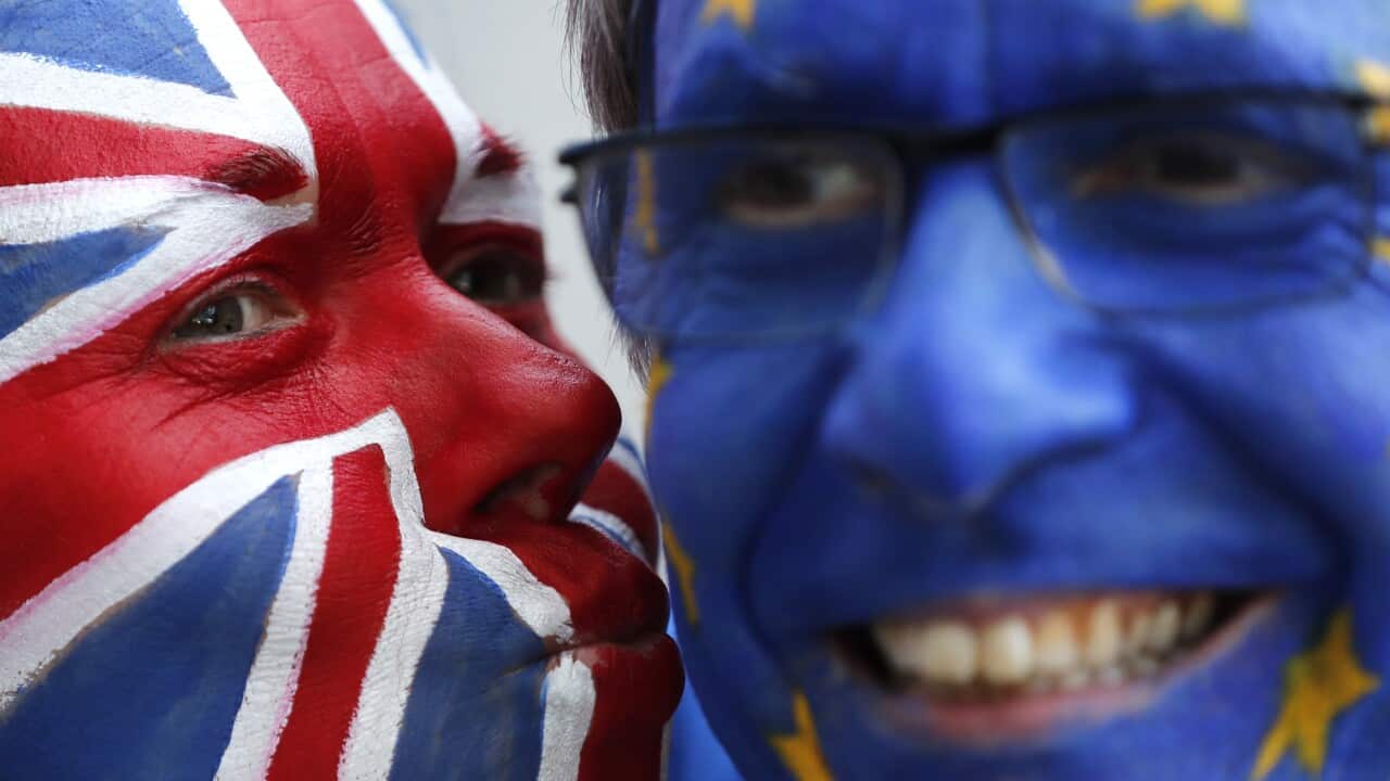 Activists poses with their faces painted in the EU and Union Flag colors during an anti-Brexit campaign stunt outside EU headquarters.