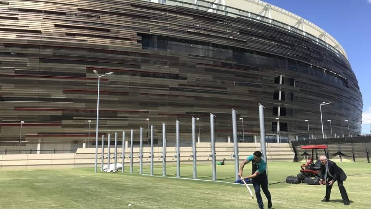 Mitchell Johnson playing cricket outside the new Optus Stadium.