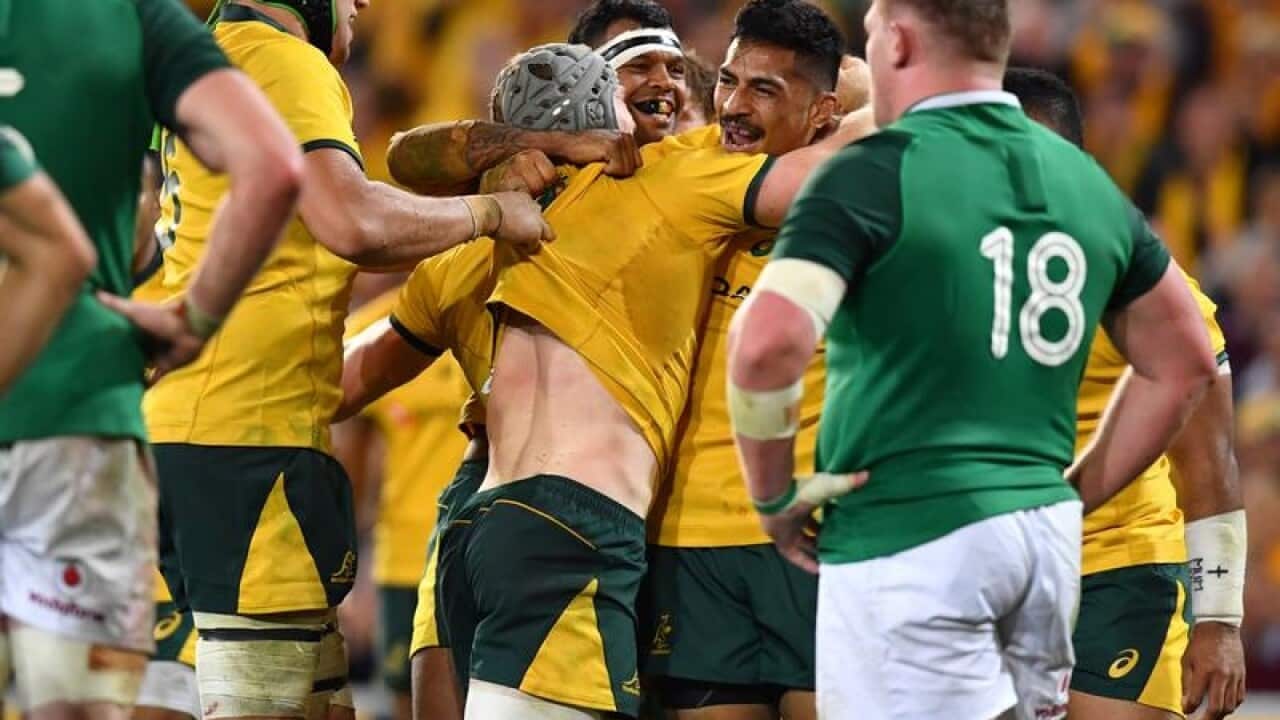 David Pocock of the Wallabies celebrates scoring a try with teammates.