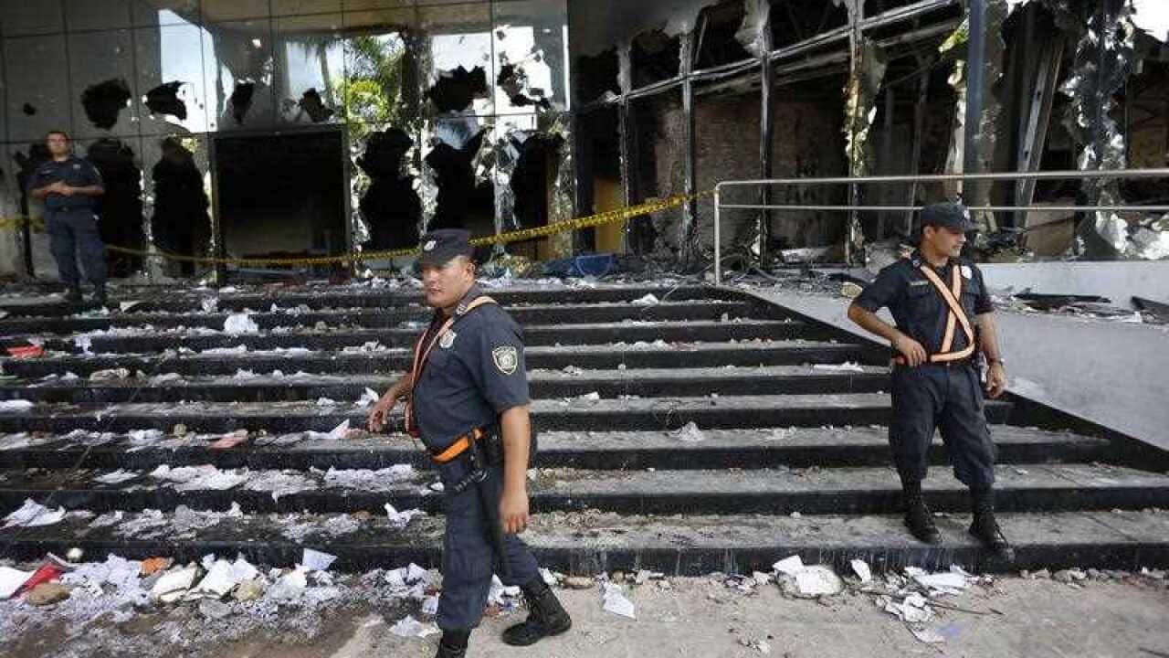 Police officers guard the Congress entrance in Asuncion, Paraguay