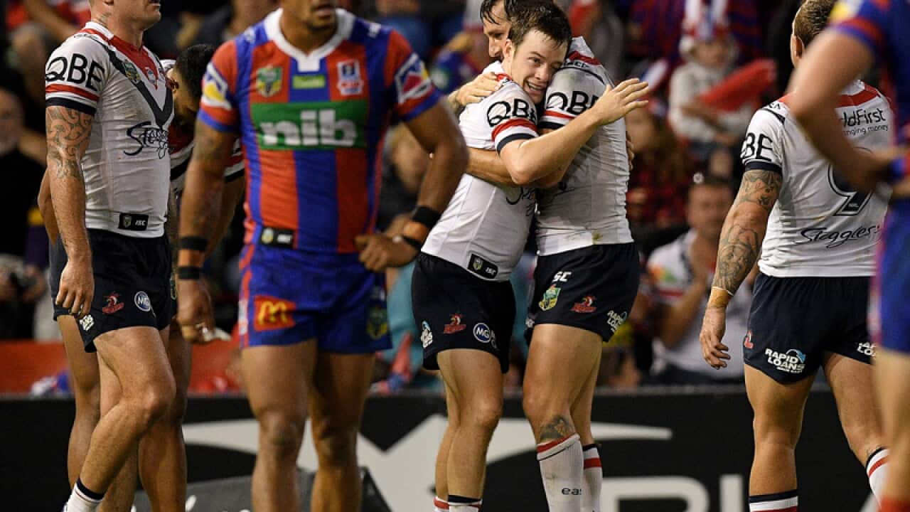 Luke Keary of the Roosters, (centre, left), celebrates