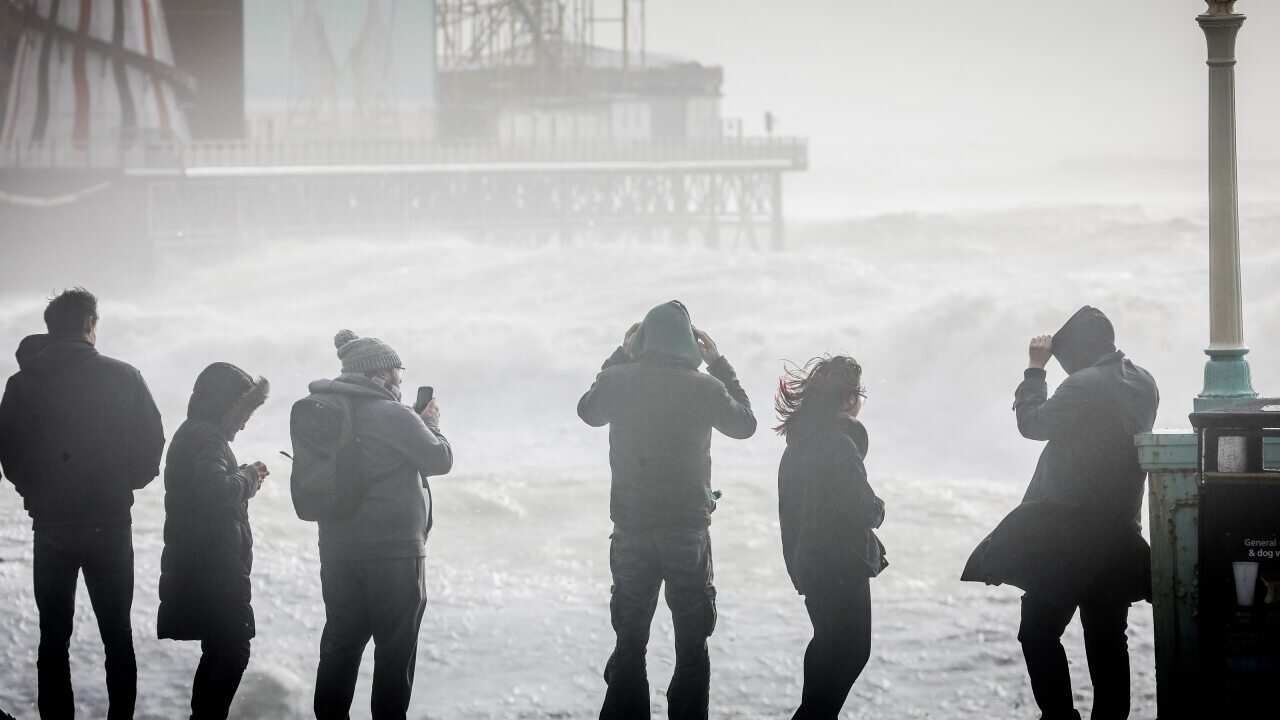 People watch as storm waves break against Brighton Palace Pier on 18 February, 2022 in Brighton, England.