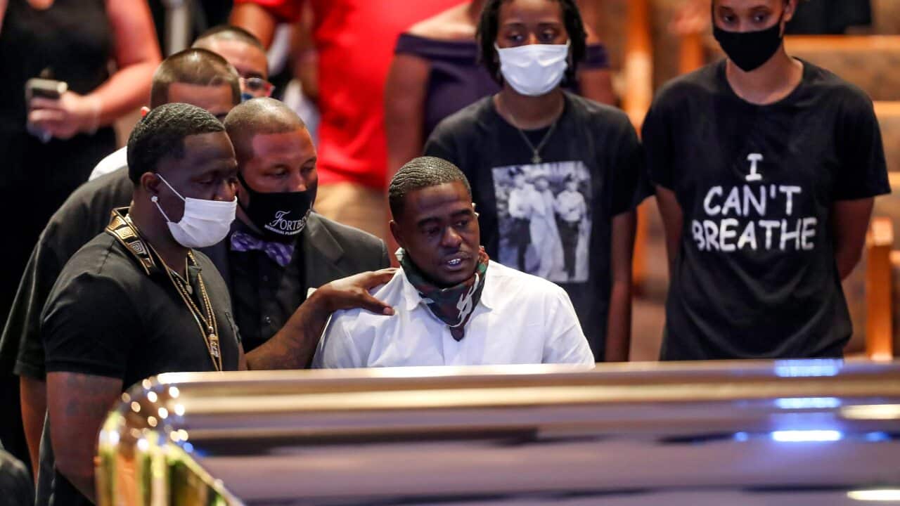 Houston rapper Cal Wayne looks at the casket during a public visitation for George Floyd in Houston.