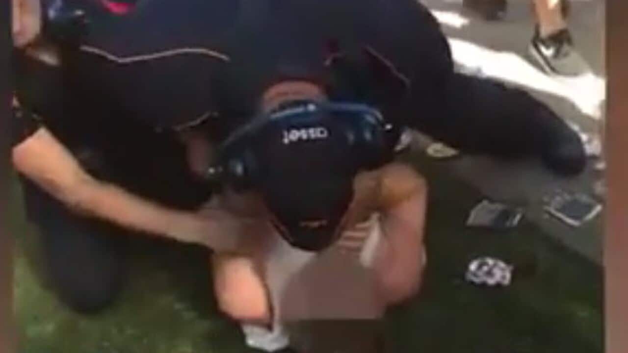 Security guard holds man down by throat at FOMO Music festival