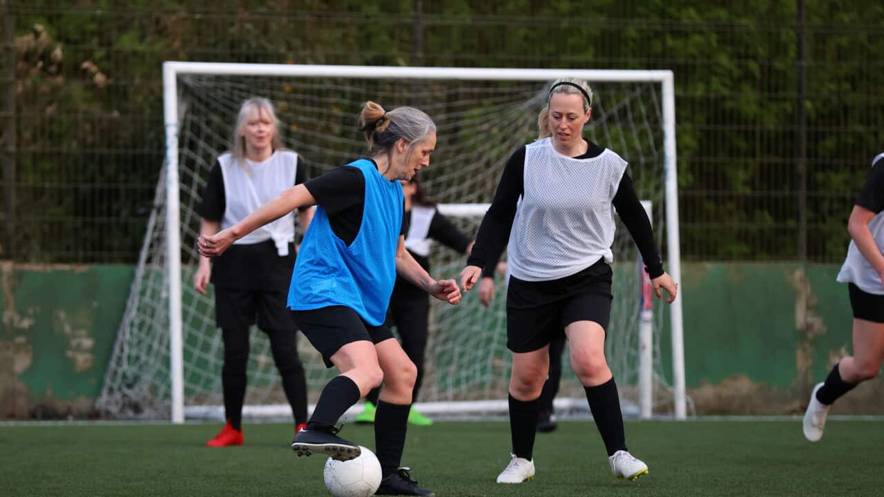 Women compete in a football match
