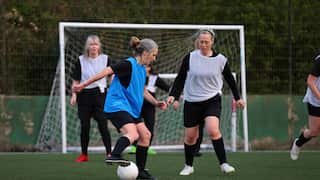 Women compete in a football match