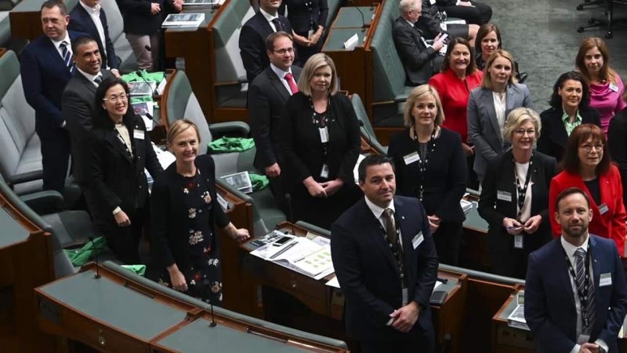 Newly elected MPs pose for photographs in parliament.