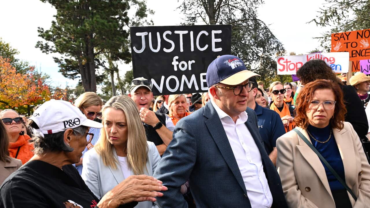 Prime Minister Anthony Albanese and Social Services Minister Annika Wells march at a rally