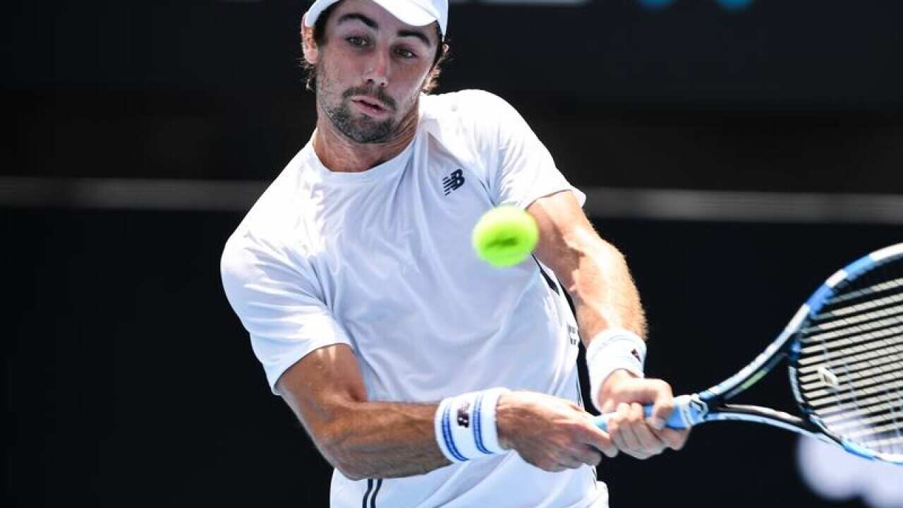 Jordan Thompson of Australia backhands against Paolo Lorenzi.