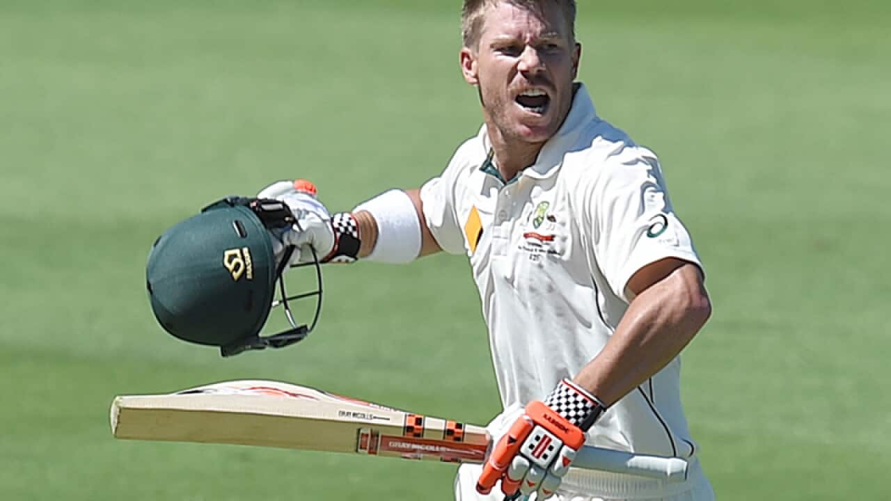 Australian batsman David Warner reacts after scoring a century