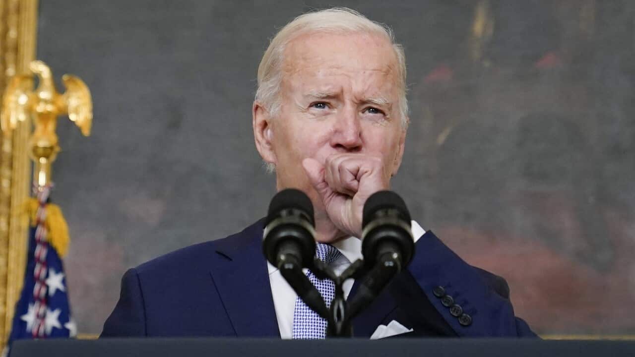 US President Joe Biden coughs during a speech at White House in Washington on 28 July 2022.