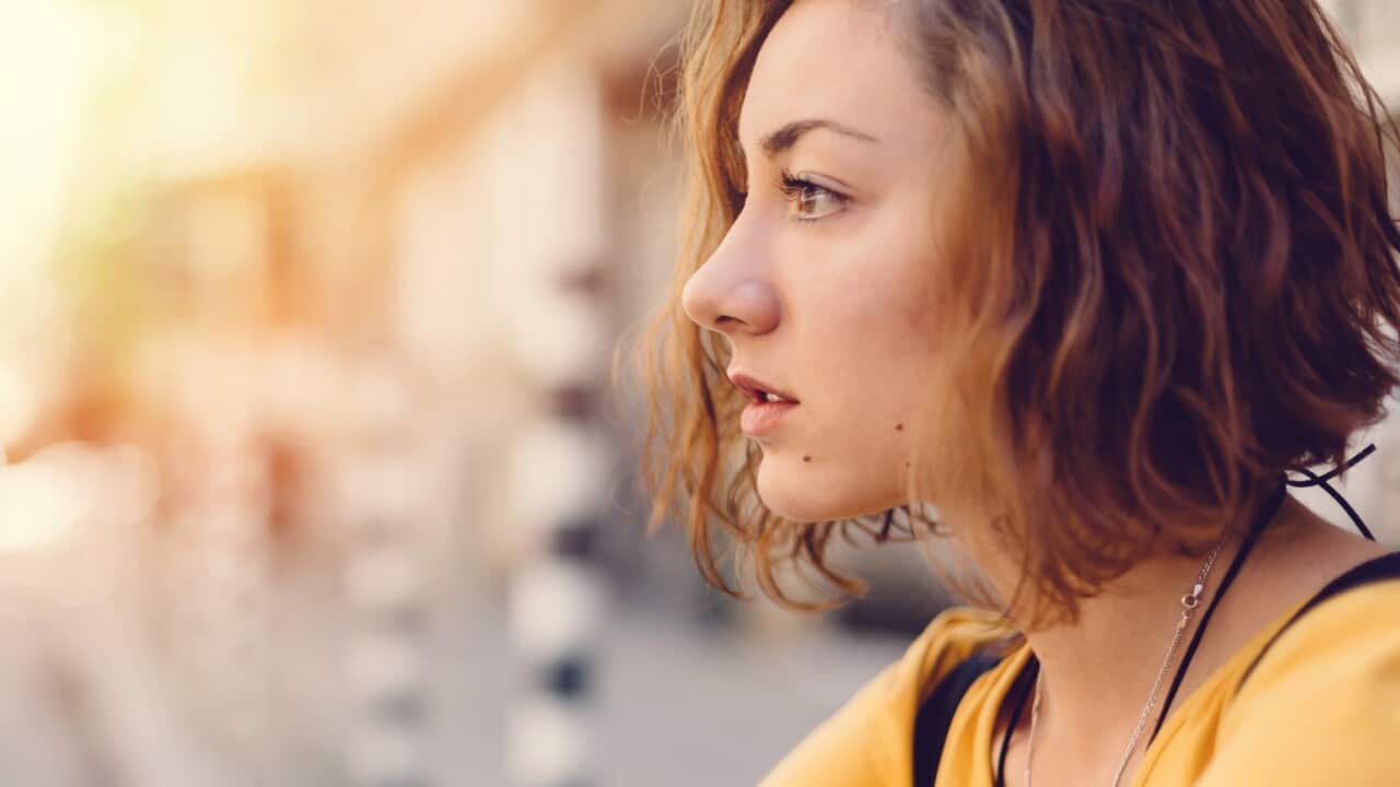Thoughtful girl at the street