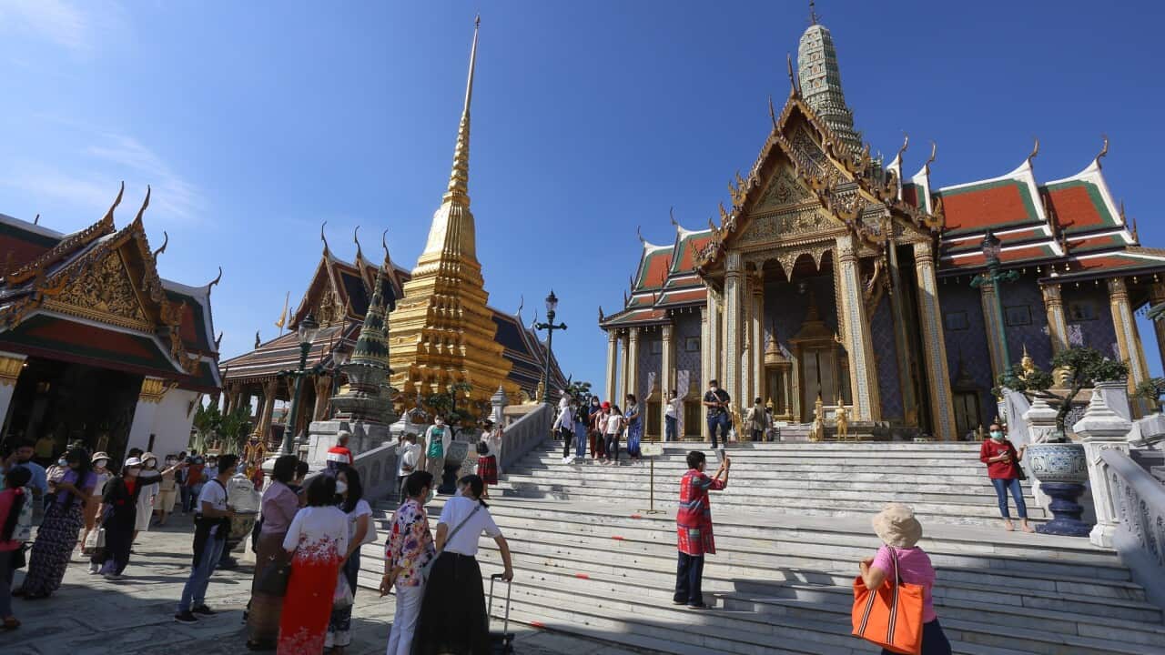 Tourists wearing facemasks as a preventive measure against the spread of coronavirus are seen at the Emerald Buddha Temple inside the Grand Palace in Bangkok. (Photo by Adisorn Chabsungnoen / SOPA Images/Sipa USA)