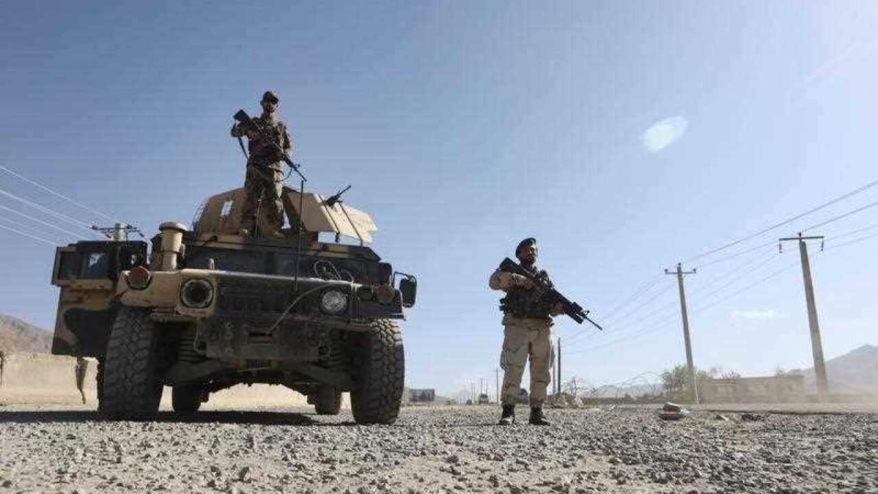 Afghan army soldiers stand guard in a checkpoint