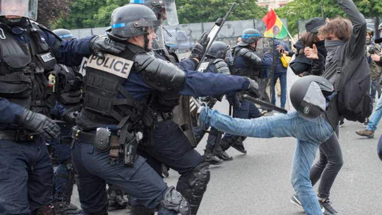 Clashes between demonstrators and riot policemen erupt during a protest against government's controversial labor reforms, on May 26, 2016, in Paris.