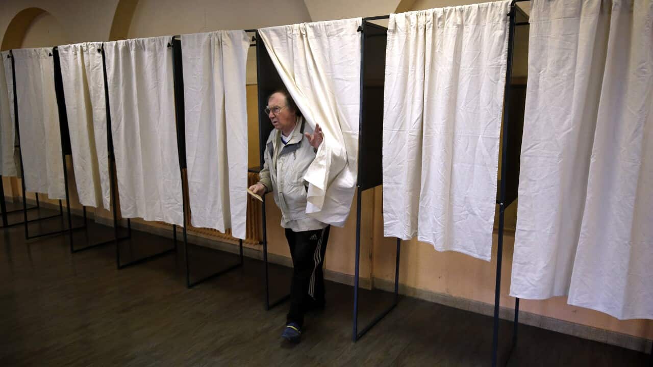 A man votes at a polling station during the second round of the French presidential elections in Nice, France.