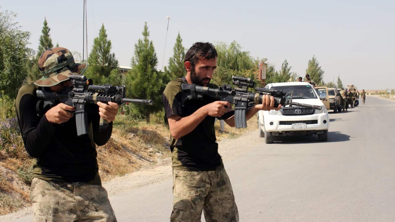 Afghan security officials stand guard at check-post as they prepare to launch a counter-offensive to regain control of the city of Kunduz.