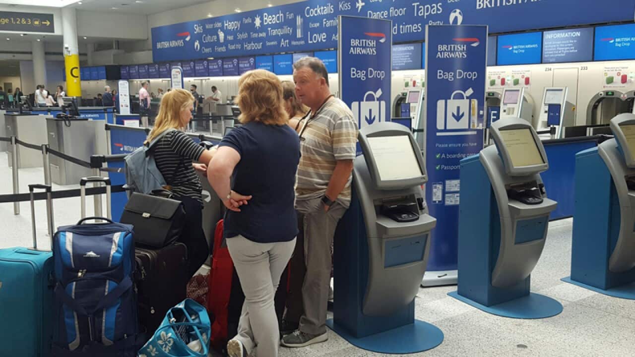 Passengers at the British Airways check-in desk at Gatwick Airport