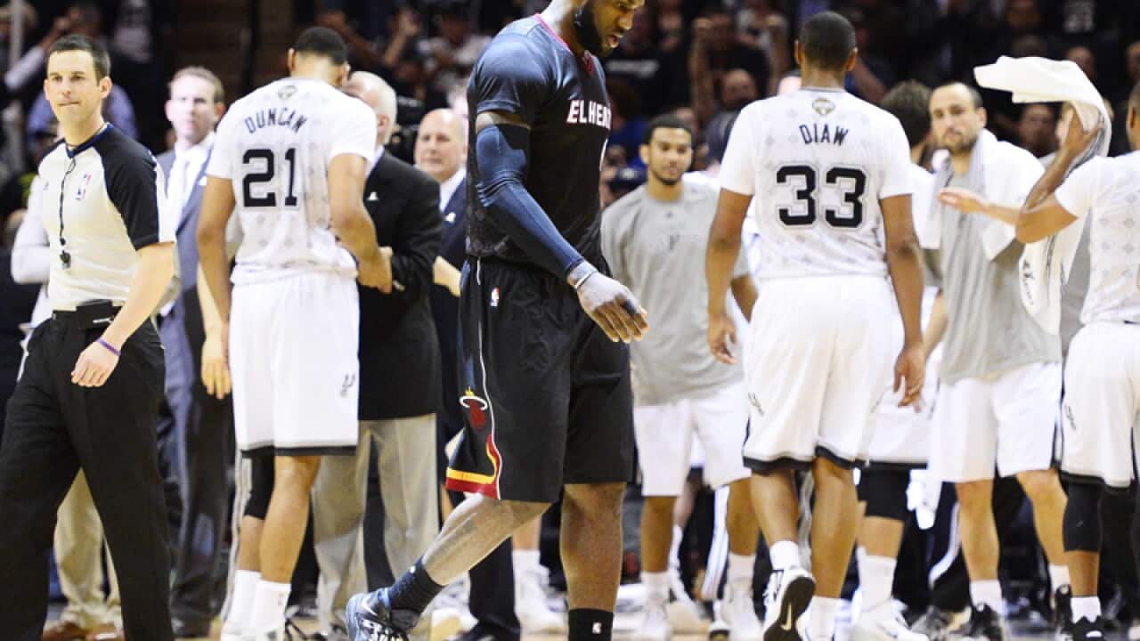 Miami Heat player LeBron James (C) against the San Antonio Spurs