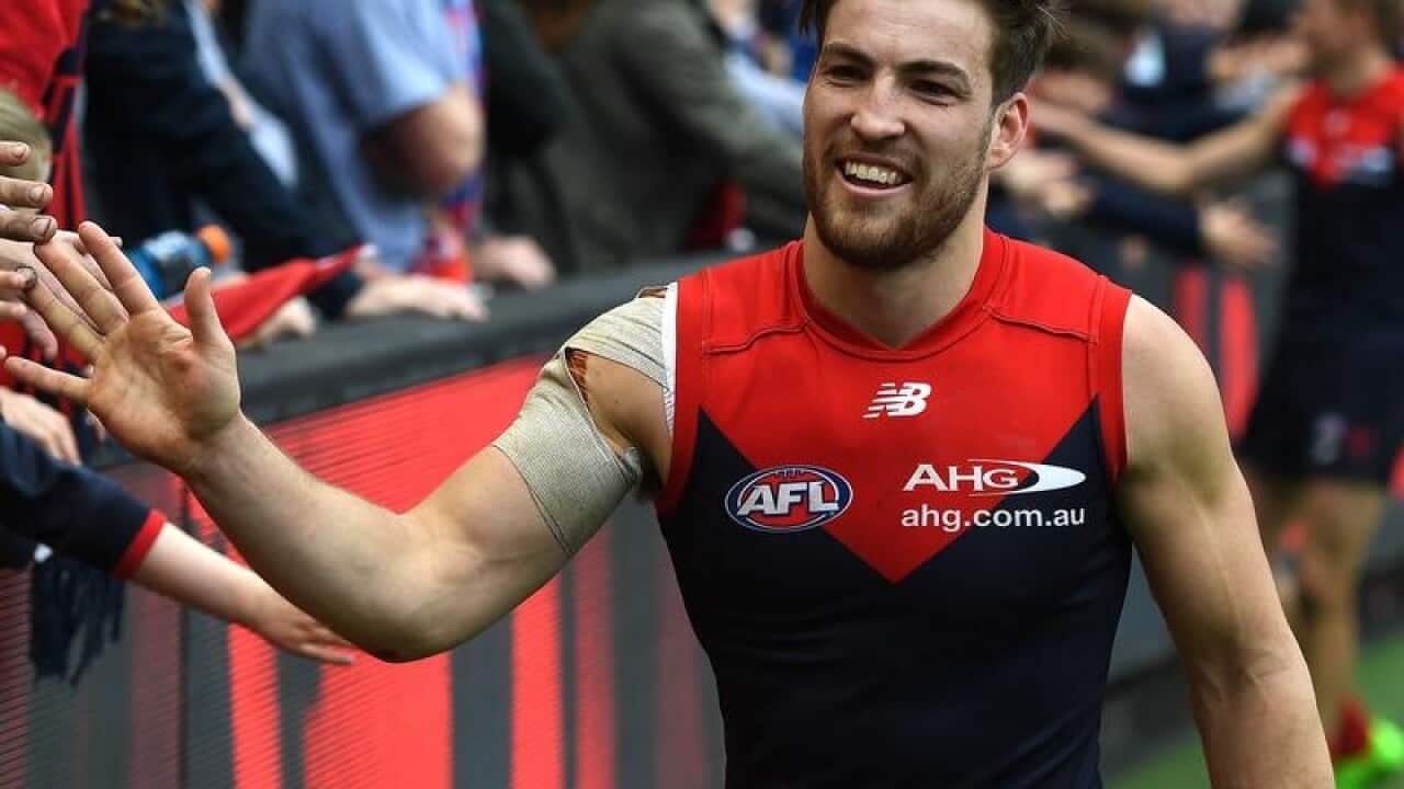 Jack Viney of the Demons hi-fives fans from the field at the MCG.