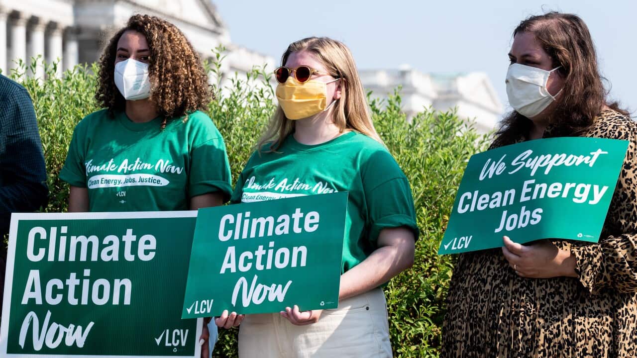 July 28, 2021 - Washington, DC, United States: Women holding up signs sayong "Climate Action Now" and "We Support Clean Energy Jobs" at a press conference where members of Congress called for climate action. (Photo by Michael Brochstein/Sipa USA)