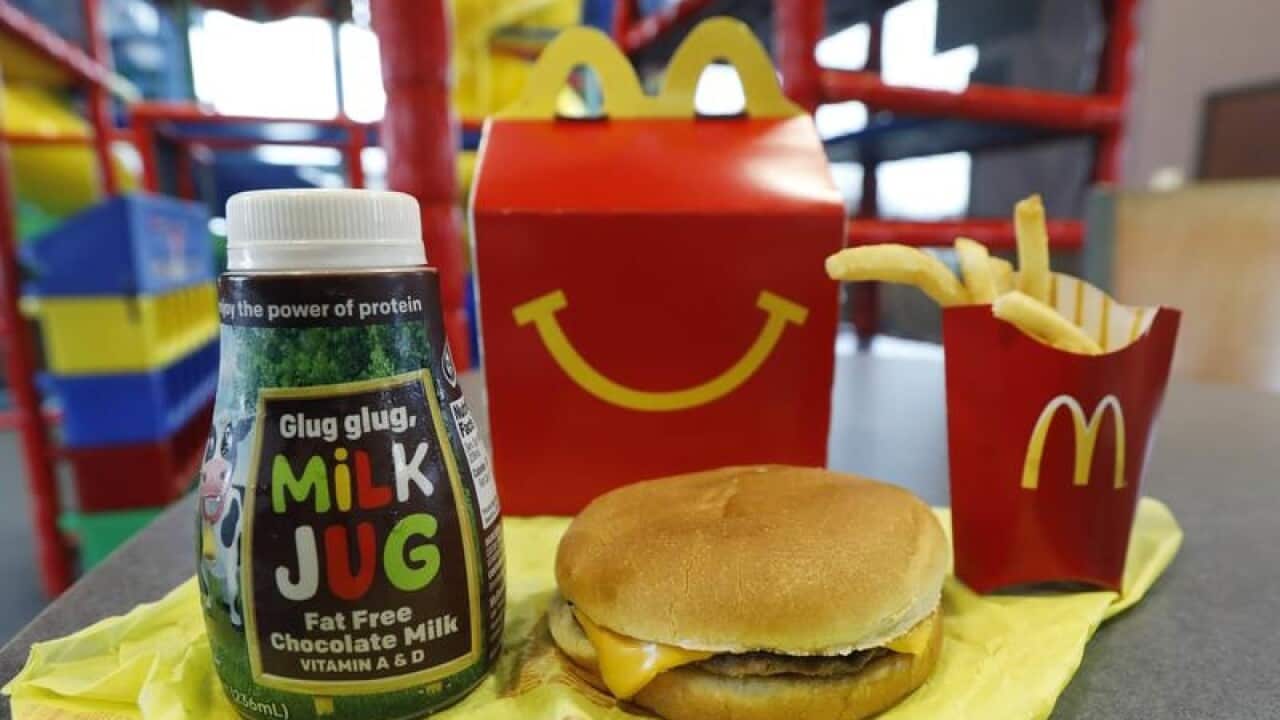 A Happy Meal featuring chocolate milk and a cheeseburger with fries