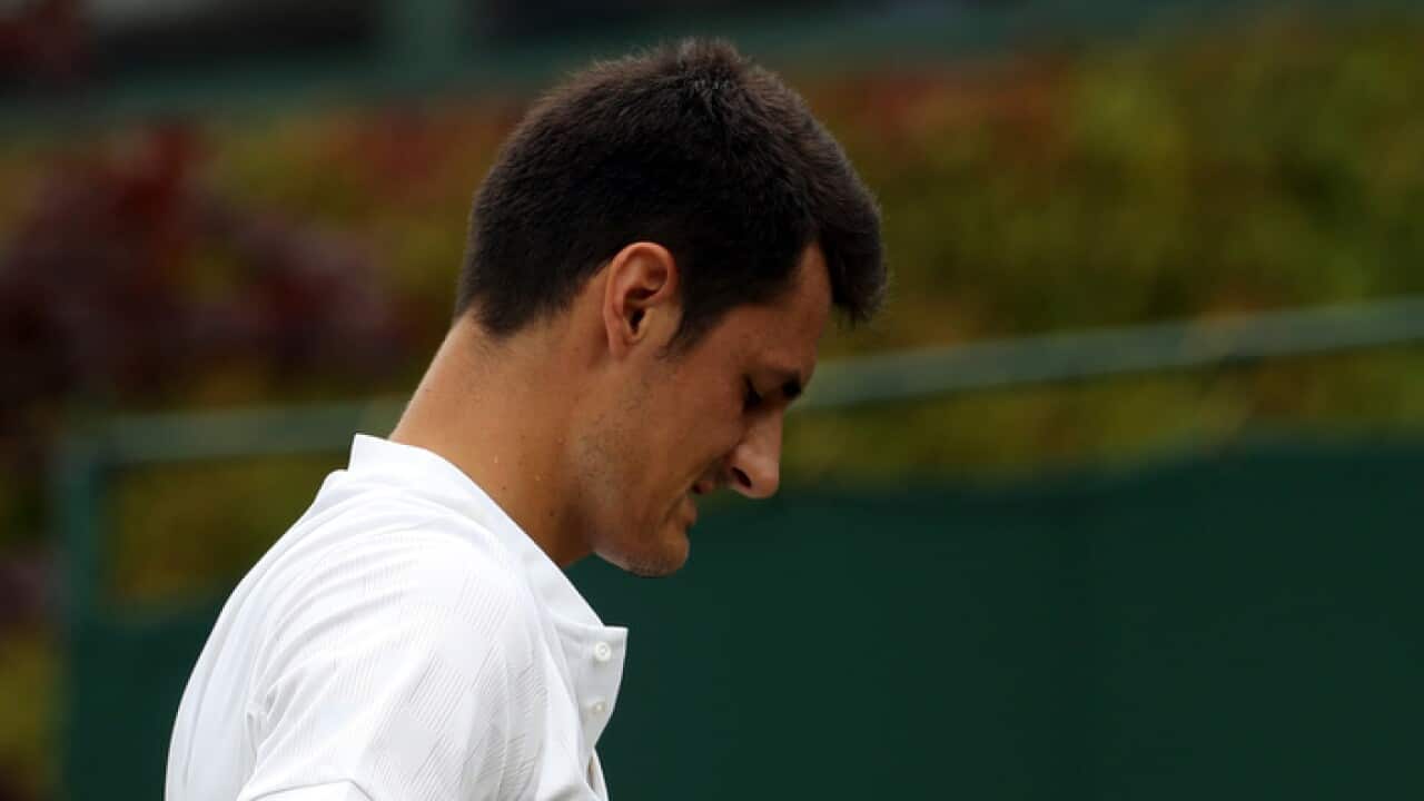 Australia's Bernard Tomic during his Men's Singles Match against Germany's Mischa Zverev at the Wimbledon Tennis Championships in London (AP Photo/Alastair Grant)