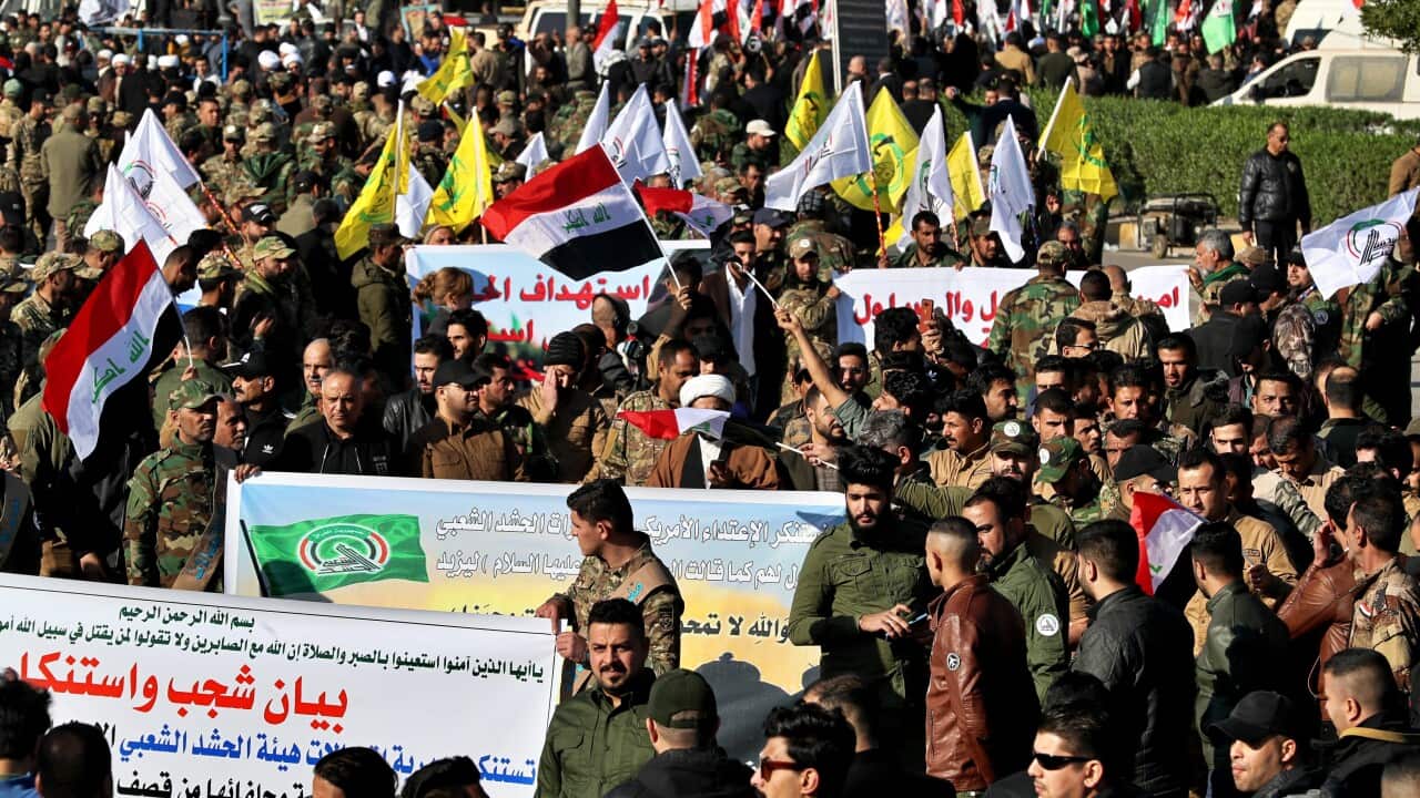 Iran-backed Popular Mobilization Forces gather outside the heavily fortified Green Zone, the seat of Iraq's government and the US embassy, in Baghdad, Iraq.
