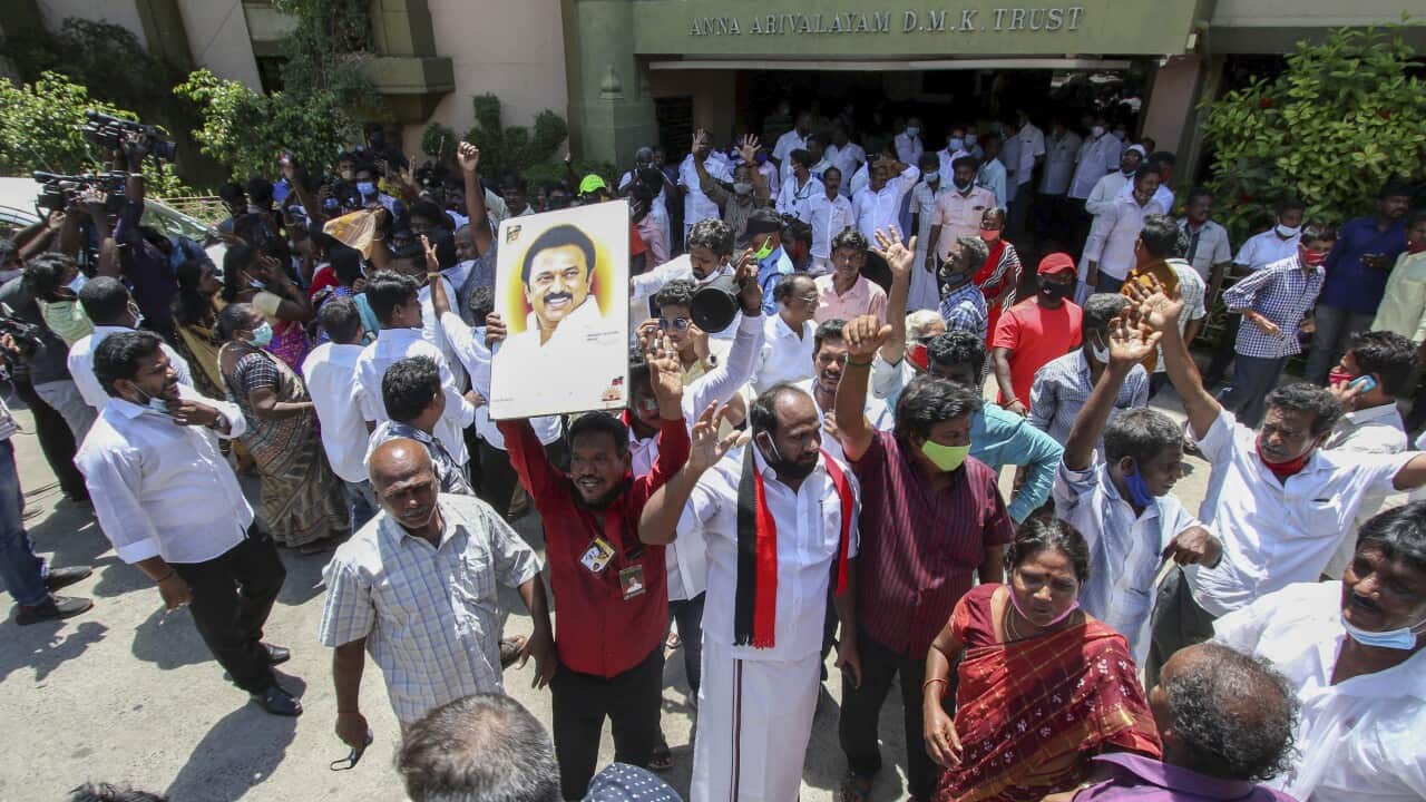 Dravida Munnetra Kazhagam (DMK) party cadres display a photograph of their leader M.K. Stalin as they celebrate early leads for the party in the Tamil Nadu state assembly elections in Chennai, India, Sunday May 2, 2021. (AP Photo/R. Parthibhan)