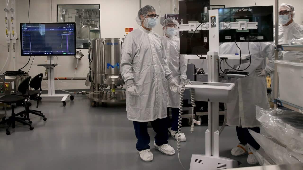 Workers in the mRNA vaccine manufacturing unit at the Moderna facility in Massachusetts