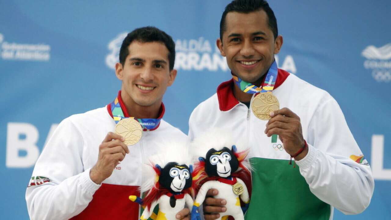 Mexican divers Jahir Ocampo (R) and Rommel Pacheco (L) poses with the gold medal in the final of the synchronized 3m men's trampoline.