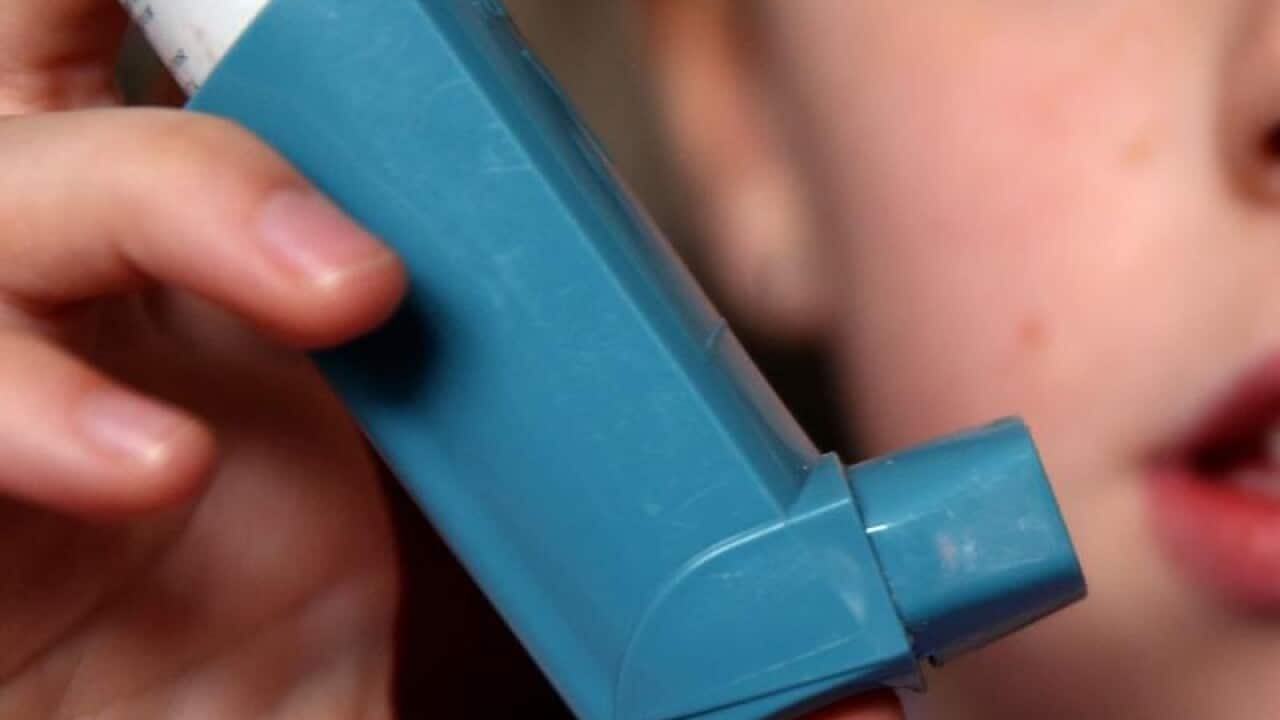 A person uses an inhaler