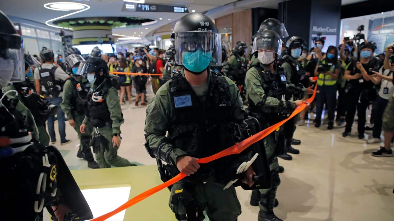Riot police during a protest to mark the one-year anniversary of the Yuen Long subway attack at a shopping mall in Hong Kong. Source: AAP