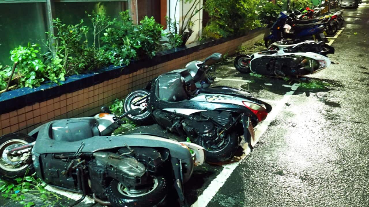 Motorcycles blown down by strong winds brought by Typhoon Megi