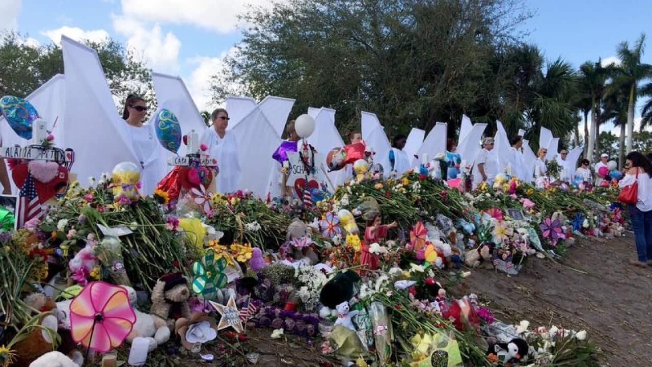 People dressed as angels outside Marjory Stoneman Douglas High School