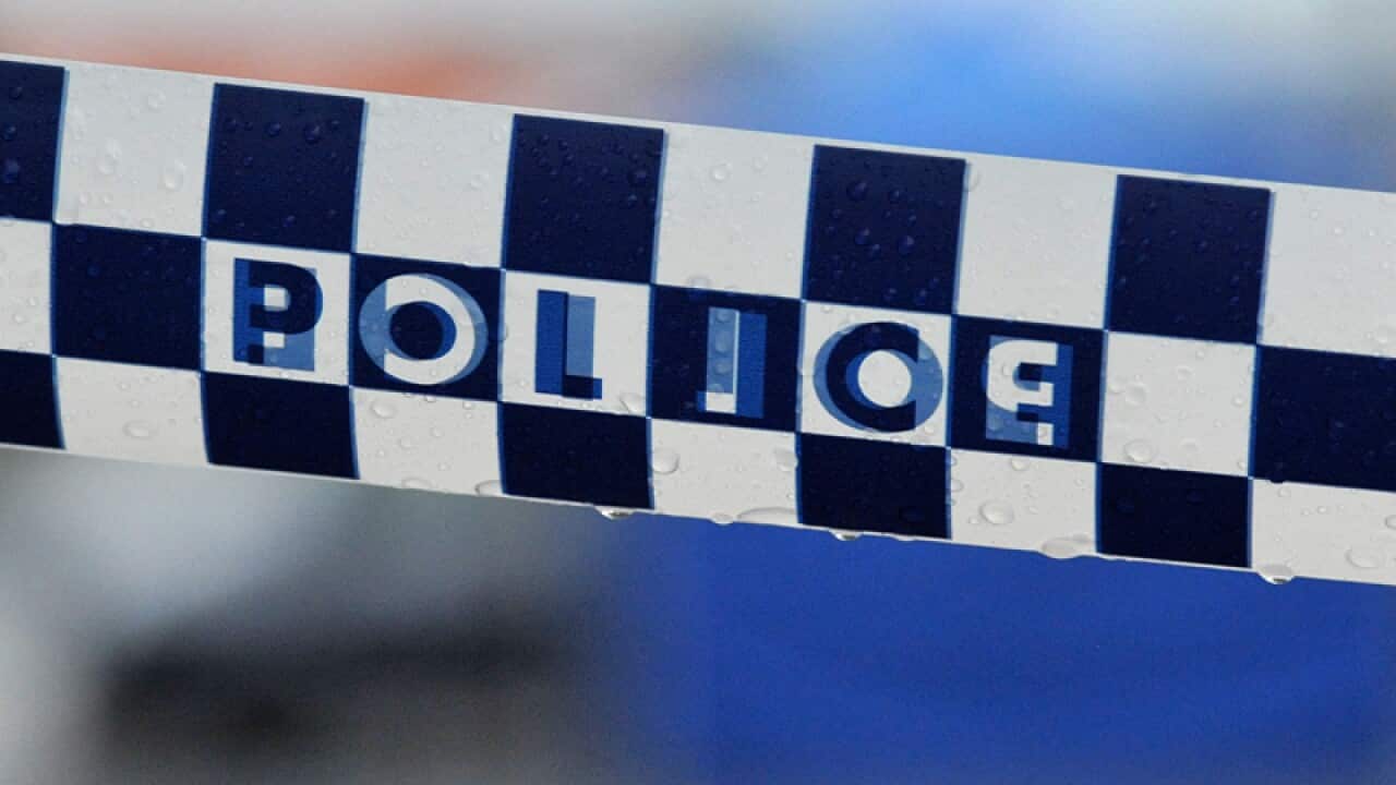 Police tape restricts access to a crime scene