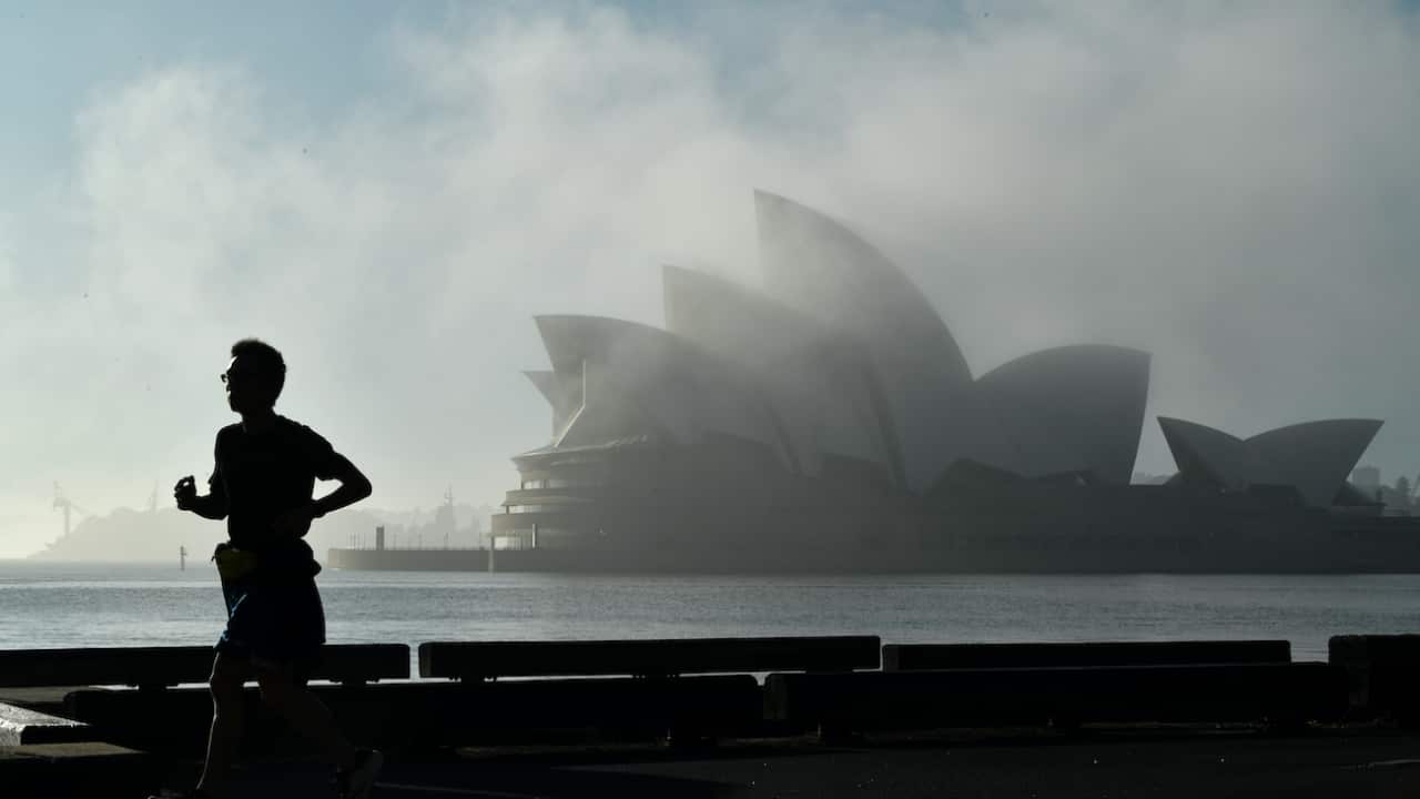 A man running past the Sydney Opera House