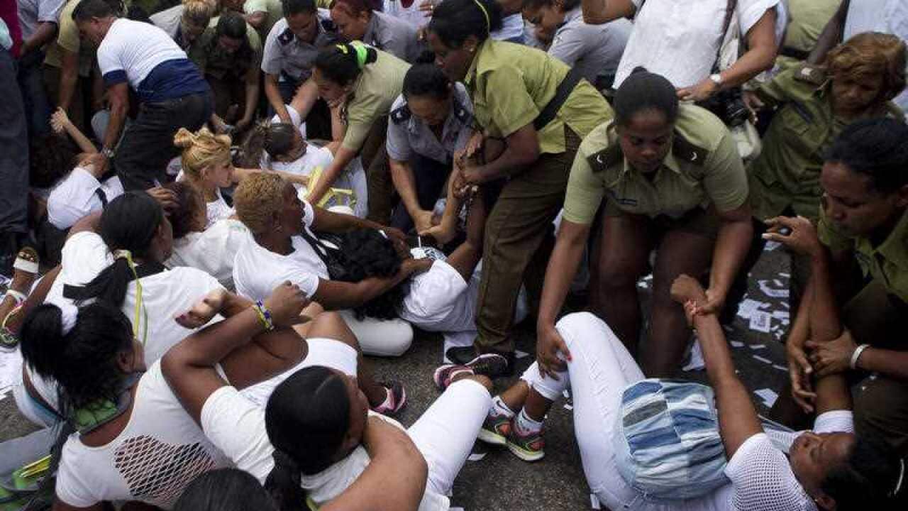 Policewomen drag away members of Ladies in White, a women's dissident group that calls for the release of political prisoners, during a protest in Havana.