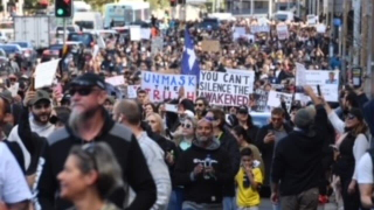 Protesters march along Broadway and George St towards Sydney Town Hall during the ‘World Wide Rally For Freedom’ anti-lockdown rally at Hyde Park in Sydney, Saturday, July 24, 2021. (AAP Image/Mick Tsikas) NO ARCHIVING