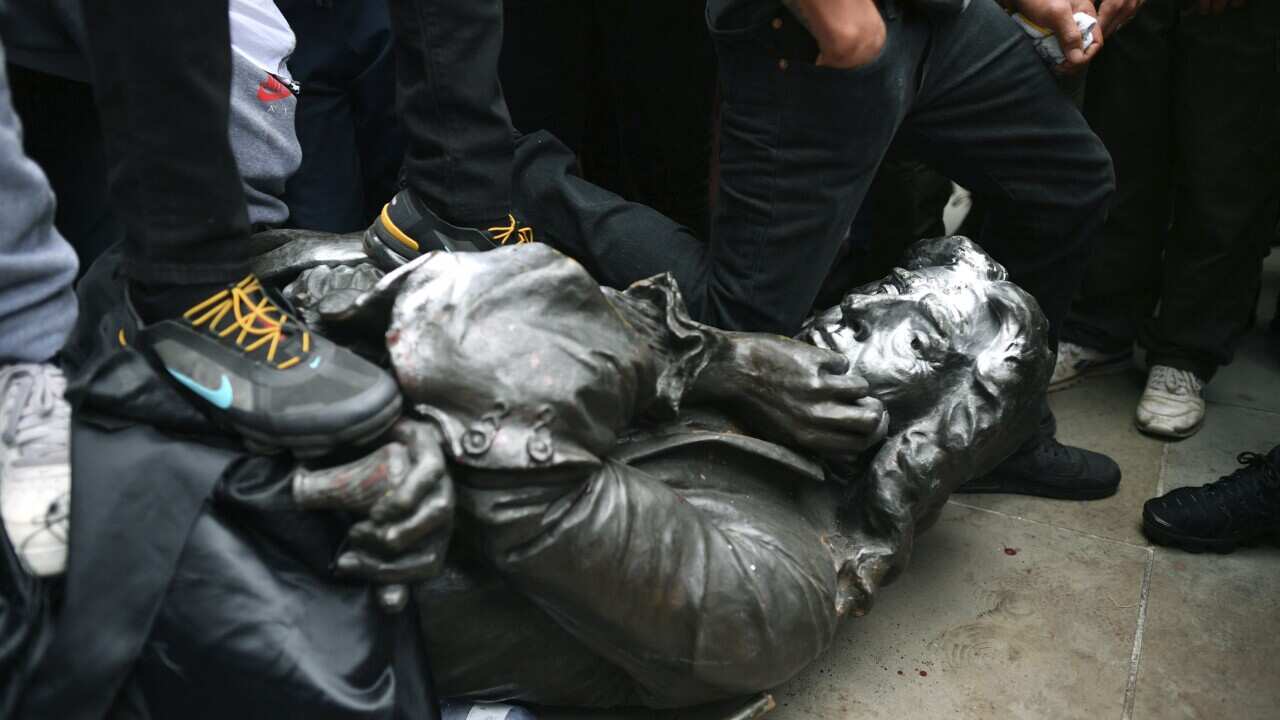 Protesters pull down a statue of Edward Colston during a Black Lives Matter protest rally in College Green, Bristol.