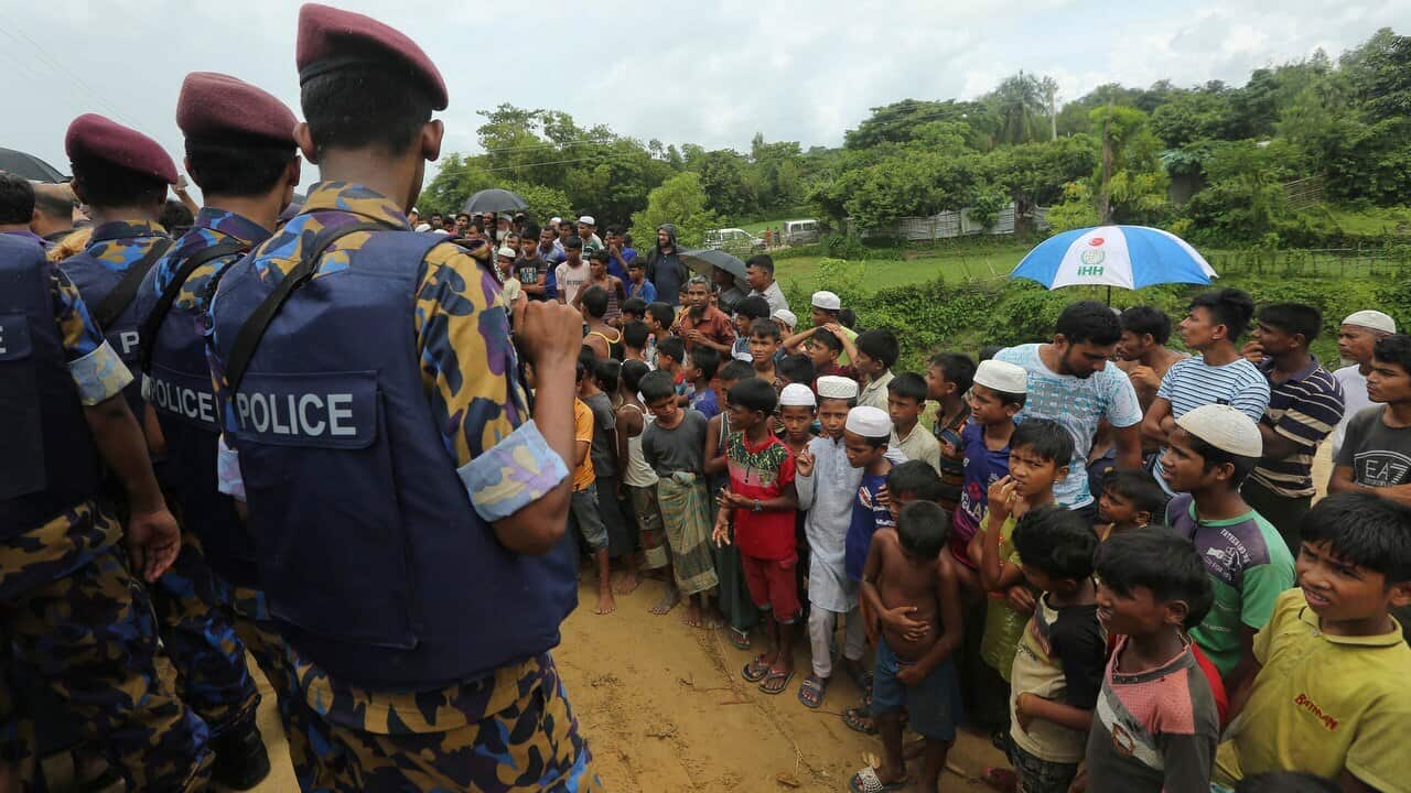 Rohingya refugee children watch Myanmarese and Chinese offcials arrive at Nayapara camp in Cox's Bazar, Bangladesh.