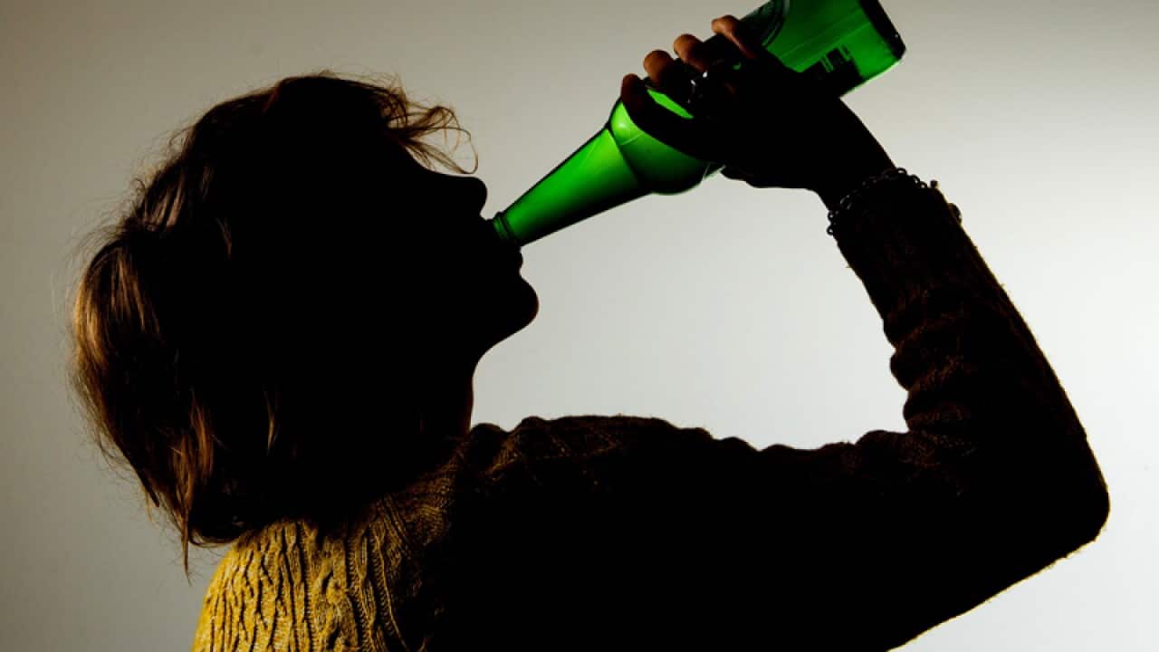 a woman drinking alcohol