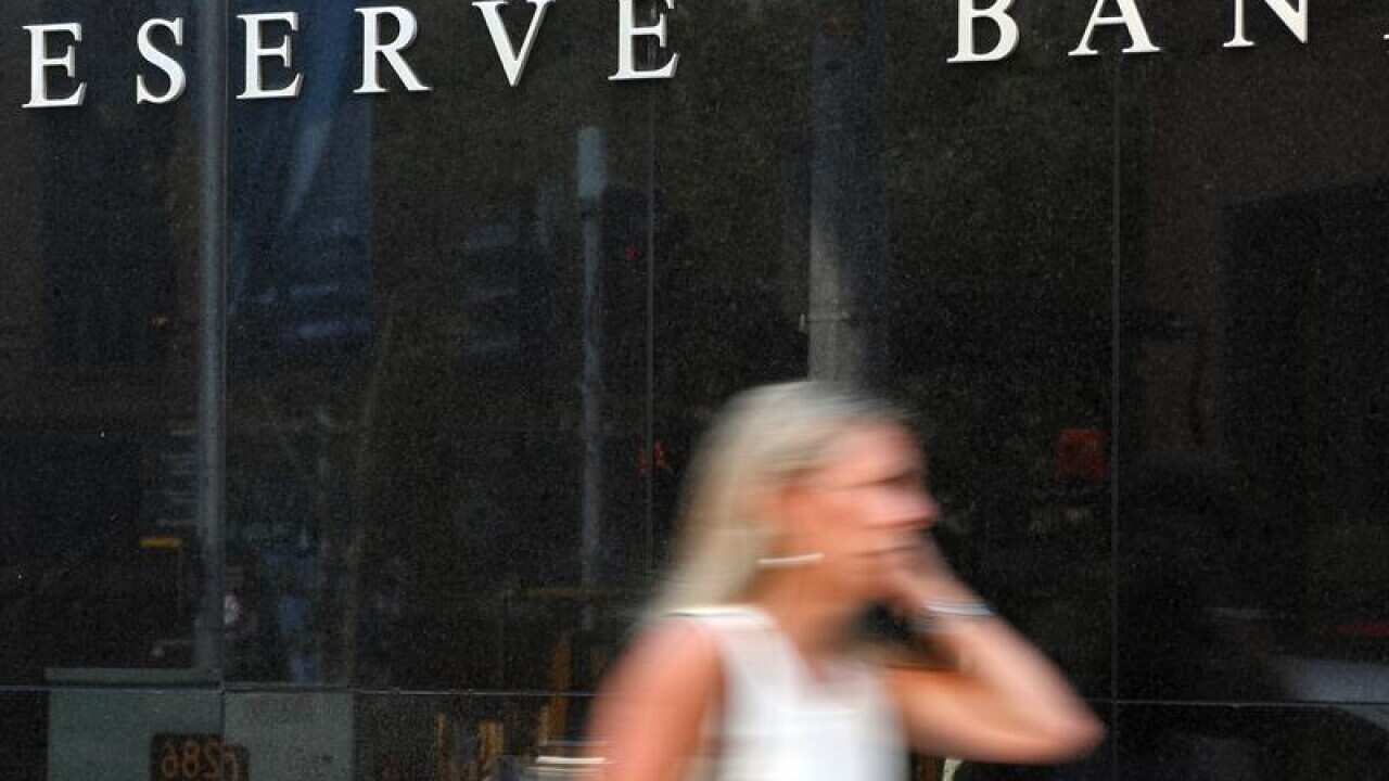 A pedestrian walks past the Reserve Bank of Australia