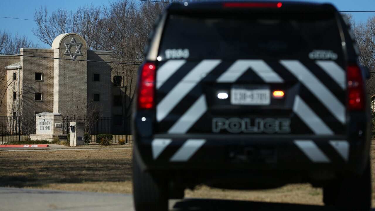 A Police vehicle sits outside of the Congregation Beth Israel Synagogue in Colleyville, Texas, 40 kilometres west of Dallas, on 16 January, 2022.
