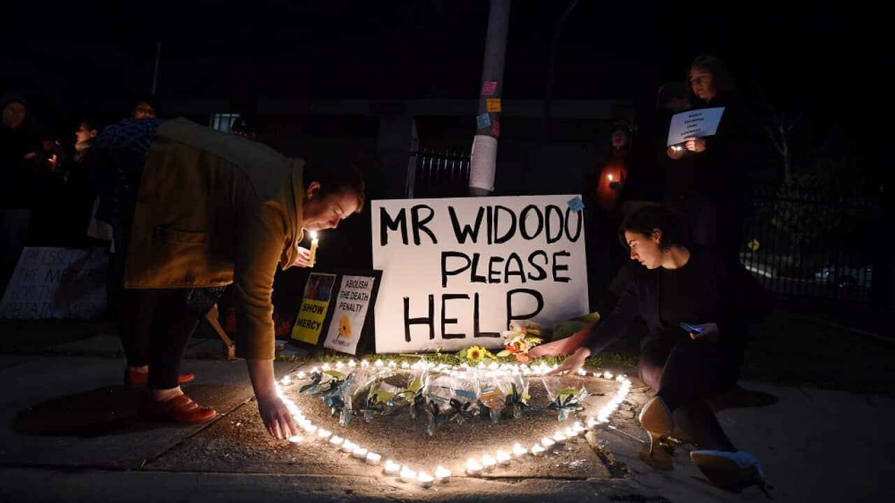 People gather to hold a vigil 